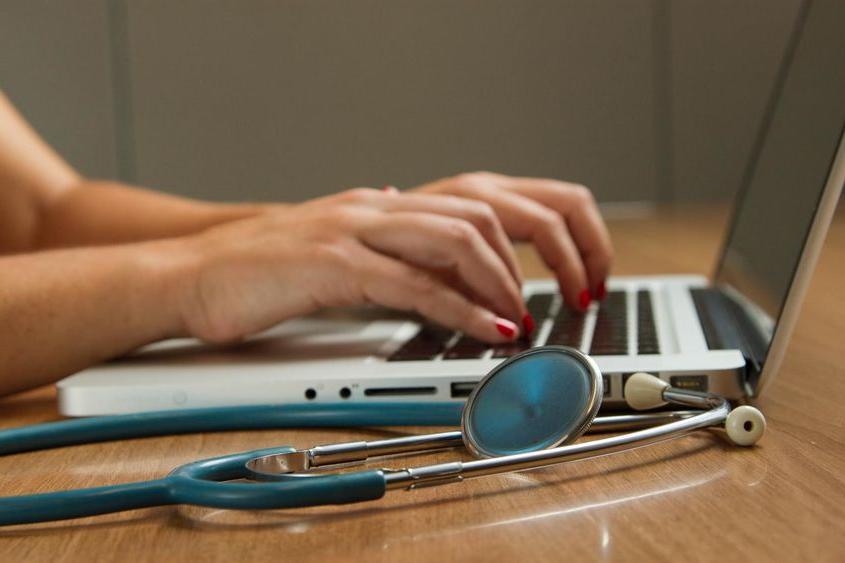 Medical examiner adding data on a laptop